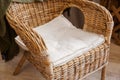 Rattan armchair with pillow close up view. Eco furniture