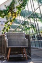 Rattan chair and other garden furniture on the summer terrace Royalty Free Stock Photo