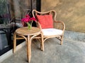 Rattan chair and table set with magenta gerbera flower Royalty Free Stock Photo