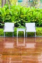 Rattan chairs and table in empty garden Royalty Free Stock Photo