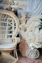 Rattan peacock chair in loft room with boho decorations