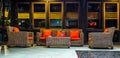 Rattan sofa with orange cushion in the lobby of a hotel Royalty Free Stock Photo