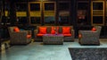 Rattan sofa with orange cushion in the lobby of a hotel Royalty Free Stock Photo