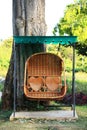 Rattan swing bench in garden