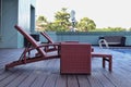 Rattan synthetic table and sunbathing chair on the side of the swimming pool