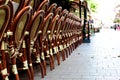 Rattan terrace chairs stacked along restaurant patio and city street Royalty Free Stock Photo