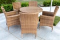 Rattan wicker furniture: table and chairs in an outdoor cafe or park Royalty Free Stock Photo