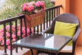 Ratten table and armchair with pillows on the balcony