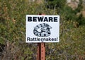 Rattlesnake Warning Sign in Desert Mountain Landscape in Badlands National Park, South Dakota Royalty Free Stock Photo