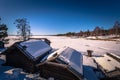 Rattvik - March 30, 2018: Wooden houses by the frozen lake Siljan in Rattvik, Dalarna, Sweden