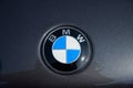 RATZEBURG, GERMANY - JUNE 2, 2019: BMW, Bavarian Motor Works, logo emblem on a black metallic motor hood, classic automobile at