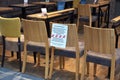 Ratzeburg, Germany, March 20, 2020: Chairs stand as a barrier in front of a cafÃÂ© and a german massage shows that it was closed