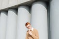 Ravenous young ginger man in glasses eating ice cream cone