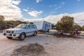 Raventhorpe, Australia - Mar 14,2021: A large white caravan and modern 4WD vehicle free camp in the outback at the old abandoned Royalty Free Stock Photo