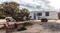 Raventhorpe, Australia - Mar 14,2021: A large white caravan and modern 4WD vehicle free camp in the outback at the old abandoned Royalty Free Stock Photo