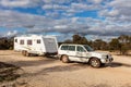 Raventhorpe, Australia - Mar 14,2021: A large white caravan and modern 4WD vehicle free camp in the outback at the old abandoned Royalty Free Stock Photo