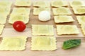 Ravioli arranged in a row with tomato, bocconcini and basil Royalty Free Stock Photo