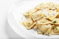 Ravioli with basil and parmesan on a white plate. White wine. Copy space. Close. Italian Cuisine