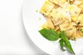 Ravioli with basil and parmesan on a white plate. White wine. Copy space. Close. Italian Cuisine