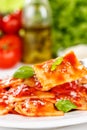 Ravioli pasta meal from Italy for lunch dish with fork and tomato sauce on a plate portrait format Royalty Free Stock Photo