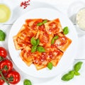 Ravioli pasta meal from Italy for lunch dish with tomato sauce top view on a plate and wooden board square Royalty Free Stock Photo