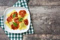 Ravioli with tomato sauce and basil on wooden background. Top view Royalty Free Stock Photo