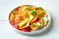 Ravioli with tomato sauce and fresh basil leaves on a plate, Italian pasta dish Royalty Free Stock Photo