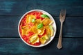 Ravioli with tomato sauce and fresh basil leaves on a plate, overhead Royalty Free Stock Photo