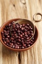 Azuki beans or red mung beans in a bowl and spoon on wooden table Royalty Free Stock Photo