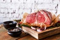 Raw aged prime black angus beef in craft papper on rustic wood Royalty Free Stock Photo