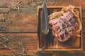 Raw aged prime black angus beef in craft papper on rustic wood Royalty Free Stock Photo