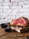 Raw aged prime black angus beef in craft papper on rustic wood