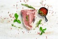 Raw aged T-bone steak with rosemary on a white wooden background. Top view. Rustic style Royalty Free Stock Photo