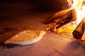 Raw Ajarian khachapuri cooked in an oven with burning firewood. Royalty Free Stock Photo