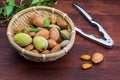 Raw almonds, peeled, with peel, skin almendrucos and almond leaves. On dark wood background.Basket with raw, peeled, shelled Royalty Free Stock Photo