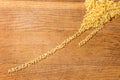 Raw alphabet pasta on cutting board lined up from heap Royalty Free Stock Photo