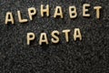 Raw Alphabet Pasta is Written with Letters on Granit Grey Surface. Royalty Free Stock Photo