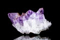 Raw amethyst mineral stone in front of black background Royalty Free Stock Photo