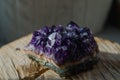 Raw amethyst rock with reflection on natural wood crystal ametist Royalty Free Stock Photo