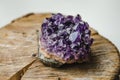 Raw amethyst rock with reflection on natural wood crystal ametist Royalty Free Stock Photo