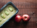 Raw apple cake before baking on a dark wooden base with apple decorations. Copy space. Pastry concept. Top view Royalty Free Stock Photo