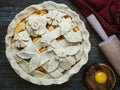 Raw apple pie decorated with flowers and leaves Royalty Free Stock Photo