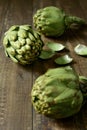 Raw artichokes on a wooden surface Royalty Free Stock Photo