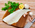 Raw atlantic cod fillet on wooden table Royalty Free Stock Photo