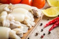 Raw babies cuttlefish with lemon and peppers Royalty Free Stock Photo