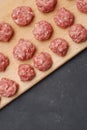 Raw Balls from Raw Beef Meat on Wooden Board over Dark Background. Copy space. Food Recipe, vertical Image. Royalty Free Stock Photo