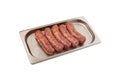 Raw barbecue sausages products on metal tray. Frankfurters. Natural meat processed foods on white background. Selective focus,