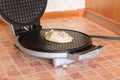 Raw batter for homemade waffles in a waffle iron Royalty Free Stock Photo