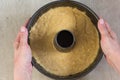 Raw batter for pumpkin cake in the bundt pan in woman hands before baking Royalty Free Stock Photo