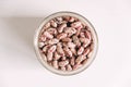 Raw beans in a glass jar on a white table background. Top view. Copy, empty space for text Royalty Free Stock Photo